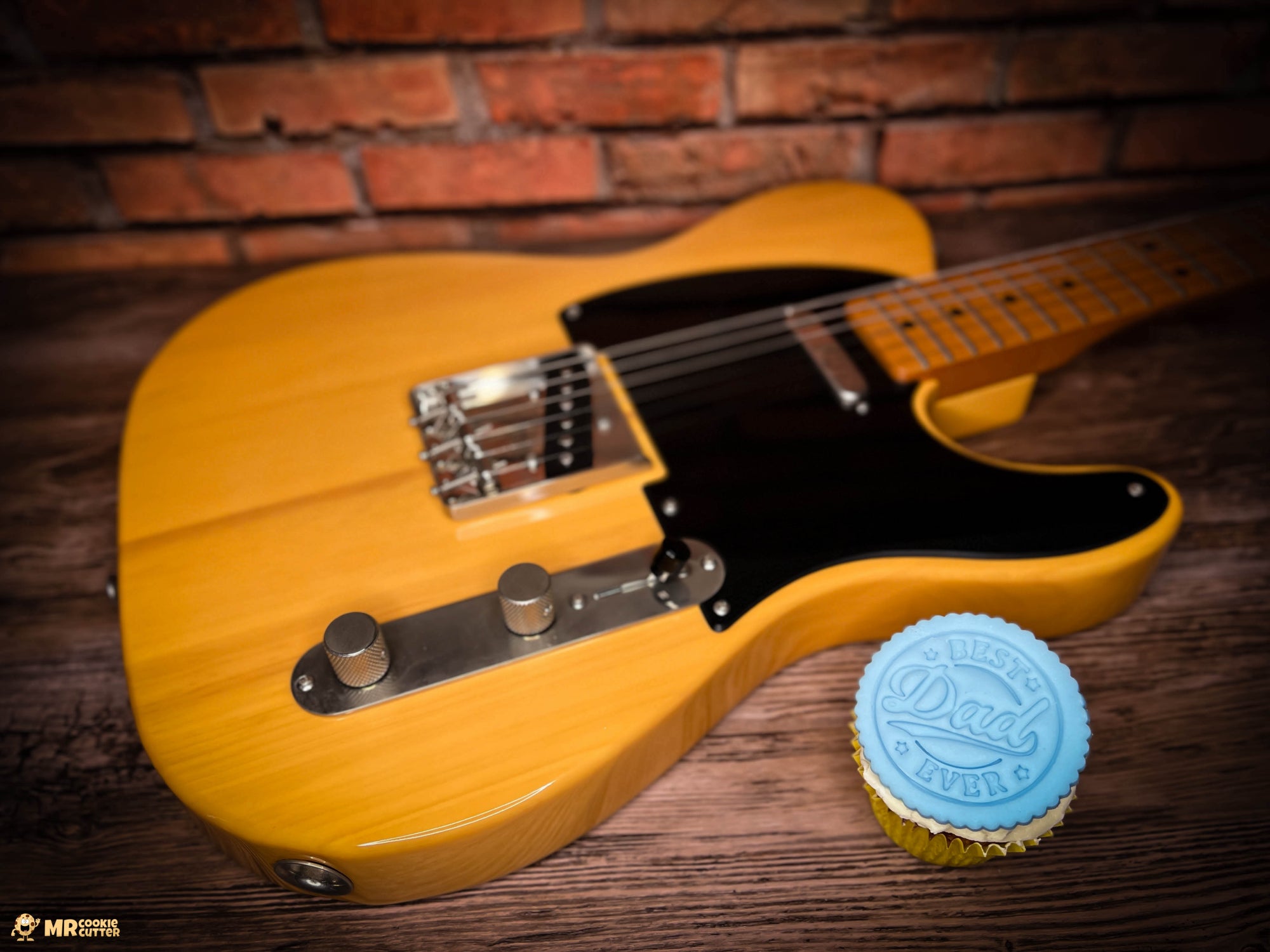 Fathers Day cupcake topper fondant stamps with a yellow guitar on a wood bench