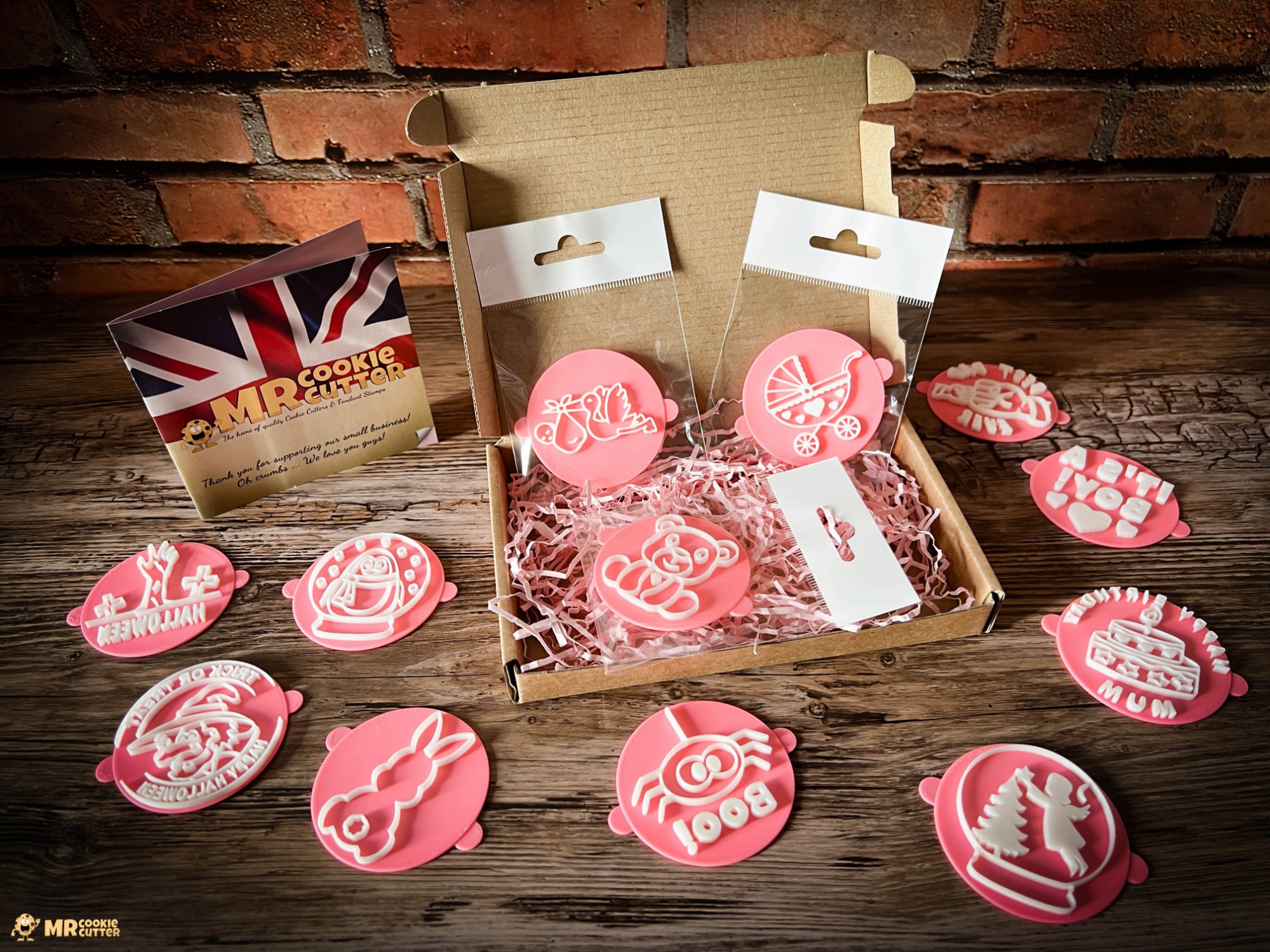 Fondant stamps in a cardboard shipping box on a wood background